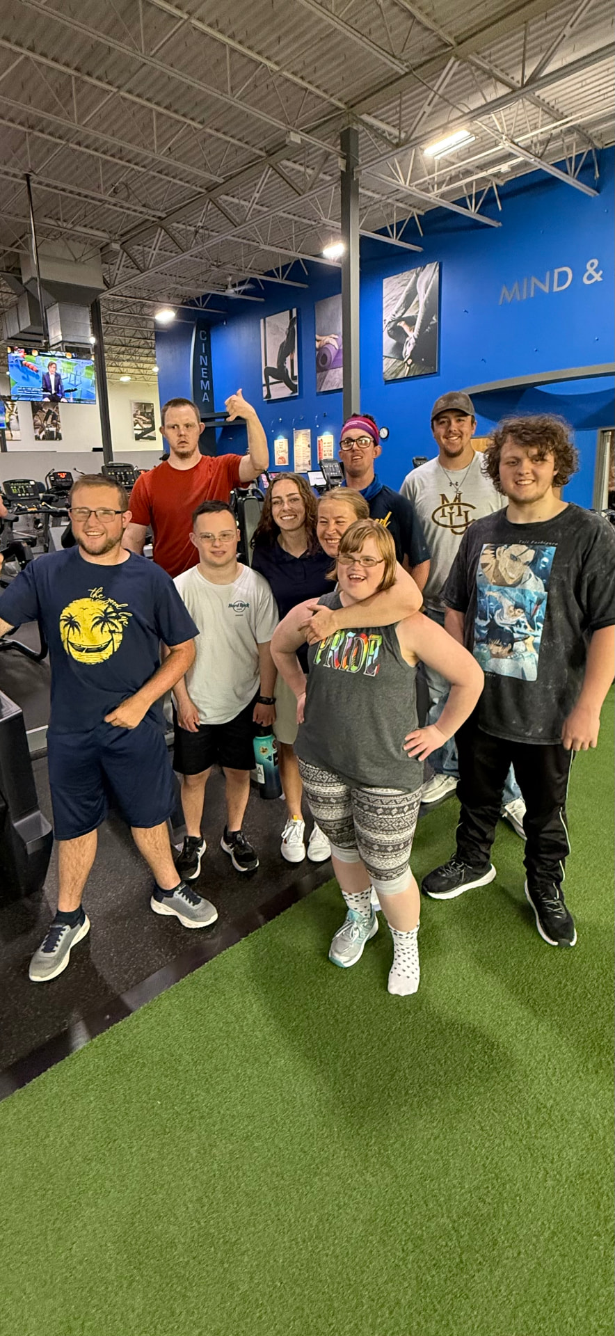 Steppin' It Up athletes and coaches smiling together in the gym