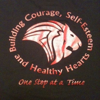 Steppin' It Up lion emblem with the motto Building Courage, Self-Esteem and Healthy Hearts, One Step at a Time